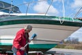 Man cleaning boat hull