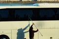 A man cleaning a bus with a squeegee Royalty Free Stock Photo