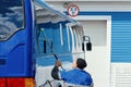 A man is cleaning a bus with a squeegee Royalty Free Stock Photo