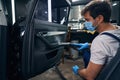 Man cleaning car door handle with steam Royalty Free Stock Photo