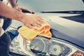 A man cleaning car with microfiber cloth