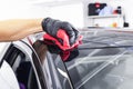 A man cleaning car with microfiber cloth. Car detailing or valeting concept. Selective focus. Car detailing. Cleaning with sponge.