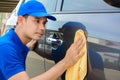 A man cleaning car with microfiber cloth