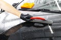A man cleaning car with plastic sponge. Car detailing or valeting concept. Selective focus. Car detailing. Cleaning with sponge an