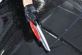 A man cleaning car with plastic sponge. Car detailing or valeting concept. Selective focus. Car detailing. Cleaning with sponge an Royalty Free Stock Photo