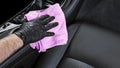 A man cleaning car seat with blue microfiber cloth. Car detailing or valeting concept. Selective focus. Car detailing. Cleaning wi Royalty Free Stock Photo