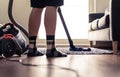 Man cleaning carpet and floor with vacuum cleaner at home. Happy person vacuuming living room rug. Tidy house. Household chores. Royalty Free Stock Photo