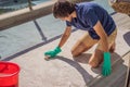 Man cleaning the carpet with foam on the balcony Royalty Free Stock Photo