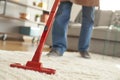 Man cleaning carpet with a vacuum cleaner in room Royalty Free Stock Photo