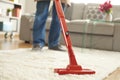 Man cleaning carpet with a vacuum cleaner in room Royalty Free Stock Photo