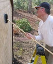 Man cleaning cedar shingles Royalty Free Stock Photo
