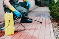 Man cleaning dirty red concrete pavement block Royalty Free Stock Photo
