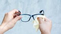 Man cleaning the glasses with microfiber fabric