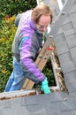 Man cleaning gutters Royalty Free Stock Photo