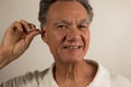 Man Cleaning his Ear with a Cotton Tip Swab Royalty Free Stock Photo