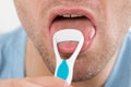 Man Cleaning His Tongue With Scraper Royalty Free Stock Photo