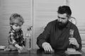 Man cleaning house together at home. Father and son with clean supplies on. Parents and child with rubber glove in foam