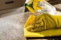 Man cleaning kitchen counter with solution to kill viruses and bacteria Royalty Free Stock Photo