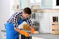 Man cleaning kitchen stove with sponge Royalty Free Stock Photo