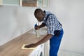 Man Cleaning Kitchen Worktop Royalty Free Stock Photo