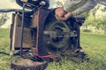 Man cleaning lawn mower blade. Royalty Free Stock Photo