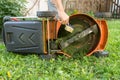 Man cleaning lawn mower Royalty Free Stock Photo