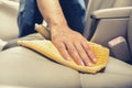 A man cleaning leather car seat with microfiber cloth Royalty Free Stock Photo