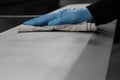 Man cleaning a metal panel with a cloth