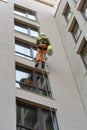 A man cleaning mirror window on a high rise building.Climber on job as Professional windows cleaner Royalty Free Stock Photo