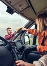 man cleaning motorhome windshield while woman pointing stain Royalty Free Stock Photo