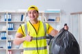 The man cleaning the office and holding garbage bag Royalty Free Stock Photo