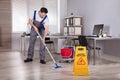 Man Cleaning Hardwood Floor In Office Royalty Free Stock Photo
