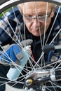 Man cleaning and oiling a bicycle chain