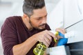 Man cleaning oven carfully Royalty Free Stock Photo