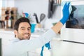 man cleaning oven in kitchen Royalty Free Stock Photo