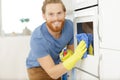 man cleaning oven in kitchen closeup Royalty Free Stock Photo