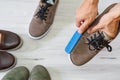 Man cleaning and polishing leather shoes with brush Royalty Free Stock Photo