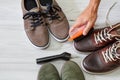 Man cleaning and polishing leather shoes with brush Royalty Free Stock Photo