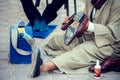 Man cleaning and polishing shoes in the street of Egypt Royalty Free Stock Photo