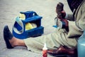 Man cleaning and polishing shoes in the street of Egypt Royalty Free Stock Photo