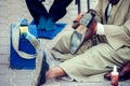 Man cleaning and polishing shoes in the street of Egypt Royalty Free Stock Photo