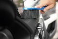 Man cleaning salon with brush, closeup