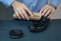 Man cleaning shoes with brush. Royalty Free Stock Photo