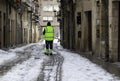 Man cleaning snowy street