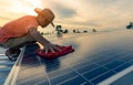 Man cleaning solar panel on roof. Solar panel or photovoltaic module maintenance. Sustainable resource and renewable energy for go Royalty Free Stock Photo
