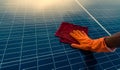 Man cleaning solar panel on roof. Solar panel or photovoltaic module maintenance. Sustainable resource and renewable energy for go Royalty Free Stock Photo