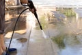 Man cleaning stone with high pressure water jet