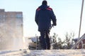 Man cleaning the street from snow manual tractor special Royalty Free Stock Photo