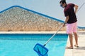 Man cleaning swimming pool