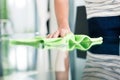 Man cleaning table in home with cloth